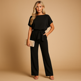 Elegant women’s jumpsuit with high waist and lace-up belt in soft draping fabric, perfect for work or casual chic occasions.