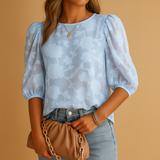 Elegant women’s floral blouse top with a flattering fit, ideal for both casual days and formal occasions in soft stylish colors.
