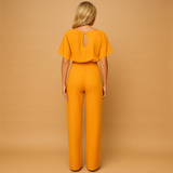 Elegant women’s jumpsuit with high waist and lace-up belt in soft draping fabric, perfect for work or casual chic occasions.