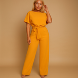 Elegant women’s jumpsuit with high waist and lace-up belt in soft draping fabric, perfect for work or casual chic occasions.