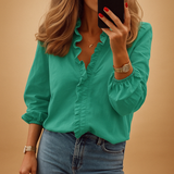 Elegant women’s blouse with subtle ruffle detailing and flattering fit, ideal for both professional and everyday looks.