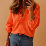 Elegant women’s blouse with subtle ruffle detailing and flattering fit, ideal for both professional and everyday looks.