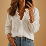 Elegant women’s blouse with subtle ruffle detailing and flattering fit, ideal for both professional and everyday looks.